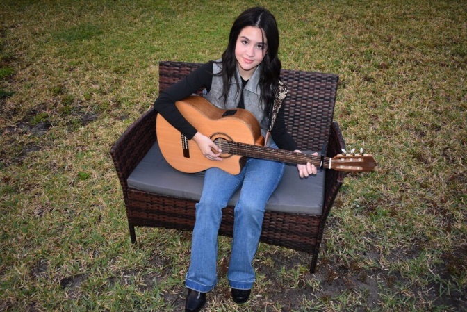 Yaeli "Yaya" Santos is learning to play the guitar as part of her curriculum under the PEP scholarship.